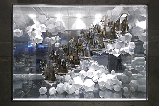 As part of the visual merchandising display, Prop Studios designed two window schemes featuring an abundance of silver miniature ships in a sea of waves